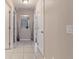 Light and bright hallway with tile floors and access to multiple rooms at 2411 Altoona Ave, North Port, FL 34286