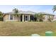 Tan house exterior with a screened porch at 2411 Altoona Ave, North Port, FL 34286