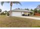 House exterior with a two-car garage and driveway at 2411 Altoona Ave, North Port, FL 34286