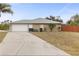 House exterior with a two-car garage and driveway at 2411 Altoona Ave, North Port, FL 34286