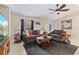 Living room with brown sofas, TV, and coffee table at 2411 Altoona Ave, North Port, FL 34286