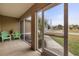 Relaxing screened porch with two green chairs and side table at 2411 Altoona Ave, North Port, FL 34286