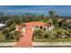 Aerial view of single-story home with a large yard and mature landscaping at 24434 Rio Togas Rd, Punta Gorda, FL 33955