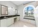 Elegant bathroom with granite countertops and a large window at 24434 Rio Togas Rd, Punta Gorda, FL 33955