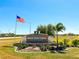 Burnt Store Lakes community entrance sign with flag at 24434 Rio Togas Rd, Punta Gorda, FL 33955