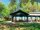 Relaxing community pavilion with picnic tables under shade trees at 24434 Rio Togas Rd, Punta Gorda, FL 33955