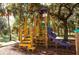 Wooden playground structure with slide and climbing features at 24434 Rio Togas Rd, Punta Gorda, FL 33955