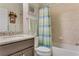 Bathroom with granite countertop, tub, and striped shower curtain at 2476 Daisy Dr, North Port, FL 34289