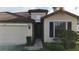 House exterior showcasing a two-car garage and a welcoming entrance at 2476 Daisy Dr, North Port, FL 34289