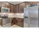 Modern kitchen with stainless steel appliances and dark cabinets at 2476 Daisy Dr, North Port, FL 34289