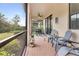 Screened porch with table and chairs, offering outdoor dining space at 2476 Daisy Dr, North Port, FL 34289