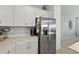 Stainless steel refrigerator and white cabinets in kitchen at 25339 Alicante Dr, Punta Gorda, FL 33955