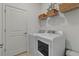 Bright laundry room with washer, dryer, and shelving at 25339 Alicante Dr, Punta Gorda, FL 33955