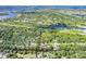 Aerial view of home nestled in a lush, wooded area near the water at 27300 San Carlos Dr, Punta Gorda, FL 33983