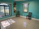 Bedroom with teal walls and two windows at 27300 San Carlos Dr, Punta Gorda, FL 33983