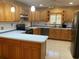 L-shaped kitchen with oak cabinets and stainless steel appliances at 27300 San Carlos Dr, Punta Gorda, FL 33983