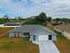 Single-story home with gray roof, white garage door, and landscaped yard at 2798 Rock Creek Dr, Port Charlotte, FL 33948