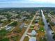 Aerial view showing neighborhood homes, roads, and canal at 2798 Rock Creek Dr, Port Charlotte, FL 33948