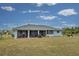 Home exterior showcasing a screened patio and grassy yard at 2798 Rock Creek Dr, Port Charlotte, FL 33948