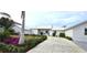 Landscaped front yard with driveway and flowering bushes at 311 Bayridge Pl, Punta Gorda, FL 33950