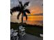 Sunset view from the patio with waterfront access and comfortable seating at 311 Bayridge Pl, Punta Gorda, FL 33950