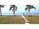 Landscaped waterfront yard with walkway leading to the water at 311 Bayridge Pl, Punta Gorda, FL 33950