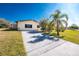 Single-story home with palm trees and a long driveway at 3200 Colony Ct, Punta Gorda, FL 33950