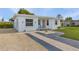 Quaint white home with light blue accents and a well-maintained lawn at 3740 Easy St, Port Charlotte, FL 33952