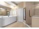 Elegant bathroom with double vanity, large mirror, and walk-in shower at 3959 San Rocco Dr # 312, Punta Gorda, FL 33950