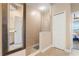 Walk-in shower with glass enclosure and adjacent linen closet at 3959 San Rocco Dr # 312, Punta Gorda, FL 33950