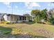 Ranch style home with screened porch and grassy yard at 4122 Library St, Port Charlotte, FL 33948