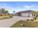 Well-maintained home offers a large driveway, spacious three-car garage and beautiful tropical landscaping at 4122 Library St, Port Charlotte, FL 33948