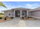 Single-story home with double doors and landscaped entryway at 4122 Library St, Port Charlotte, FL 33948