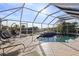 Inviting pool area with screened enclosure and lounge chairs at 4122 Library St, Port Charlotte, FL 33948