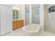 Large bathroom with soaking tub, shower, and double vanity at 437 Loveland Blvd, Port Charlotte, FL 33954