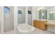 Large bathroom with soaking tub, shower, and double vanity at 437 Loveland Blvd, Port Charlotte, FL 33954