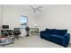 Cozy bedroom featuring a blue sofa and workspace at 437 Loveland Blvd, Port Charlotte, FL 33954