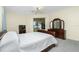 Bedroom with wooden sleigh bed and dresser at 437 Loveland Blvd, Port Charlotte, FL 33954