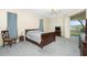 Bedroom with wooden bed and backyard access at 437 Loveland Blvd, Port Charlotte, FL 33954