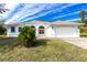 Single-Gathering home with two-car garage and landscaped yard at 437 Loveland Blvd, Port Charlotte, FL 33954