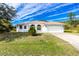 Single-Gathering home with two-car garage and landscaped yard at 437 Loveland Blvd, Port Charlotte, FL 33954