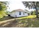 Side view showcasing the home's exterior and landscaping at 437 Loveland Blvd, Port Charlotte, FL 33954