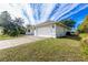 Single-story home with attached garage and well-manicured lawn at 437 Loveland Blvd, Port Charlotte, FL 33954