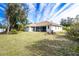 Back of house with screened patio and yard at 437 Loveland Blvd, Port Charlotte, FL 33954