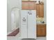 White refrigerator in kitchen with wood cabinets at 437 Loveland Blvd, Port Charlotte, FL 33954