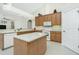 Kitchen with light wood cabinets, an island, and a view of the living room at 437 Loveland Blvd, Port Charlotte, FL 33954