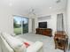 Living room features sliding doors to backyard and a ceiling fan at 437 Loveland Blvd, Port Charlotte, FL 33954