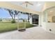 Spacious screened porch overlooking backyard, featuring a ceiling fan and sliding glass doors at 437 Loveland Blvd, Port Charlotte, FL 33954