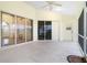 Spacious screened porch with sliding glass doors and ceiling fan at 437 Loveland Blvd, Port Charlotte, FL 33954