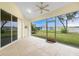 Bright screened porch with ceiling fan, access to backyard, and sliding glass doors at 437 Loveland Blvd, Port Charlotte, FL 33954